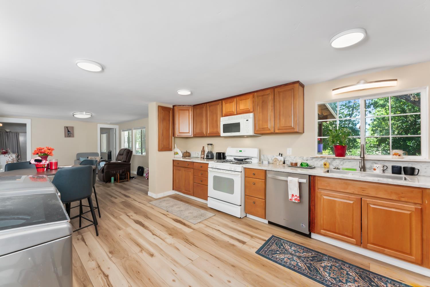 1525 Cold Springs Road, Unit 97 Placerville, CA 95667 - Photo 22 of 48 a open kitchen with stainless steel appliances granite countertop a stove top oven a sink dishwasher and cabinets with wooden floor