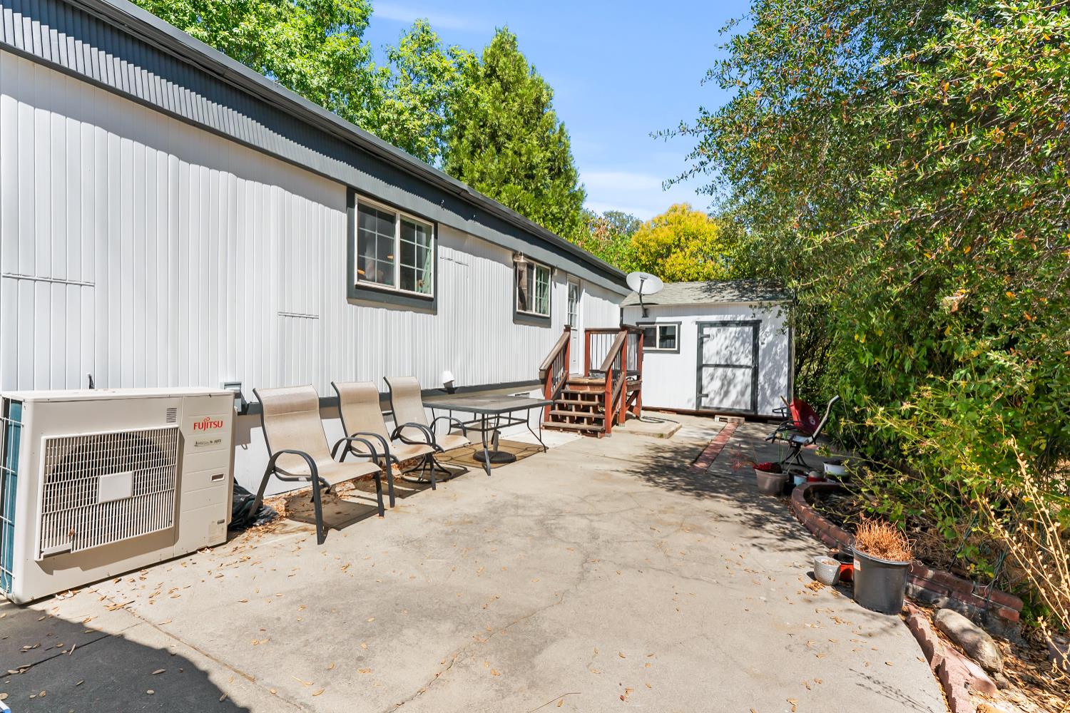 1525 Cold Springs Road, Unit 97 Placerville, CA 95667 - Photo 38 of 48 a view of a patio with table and chairs and a barbeque