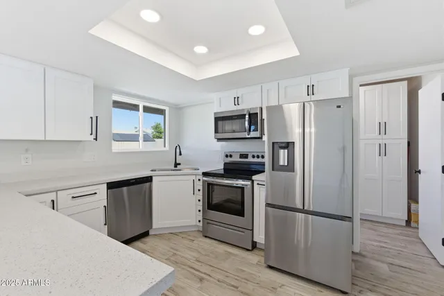a kitchen with a refrigerator stove and sink