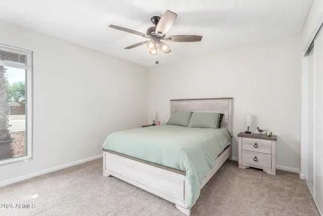 a spacious bedroom with a bed and window