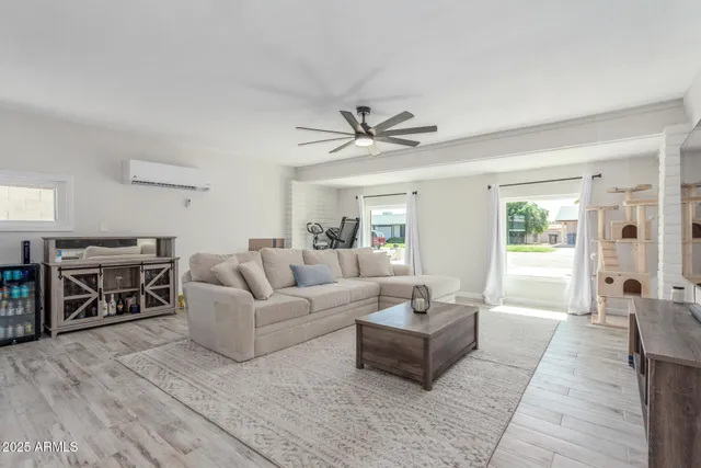 a living room with furniture and a wooden floor