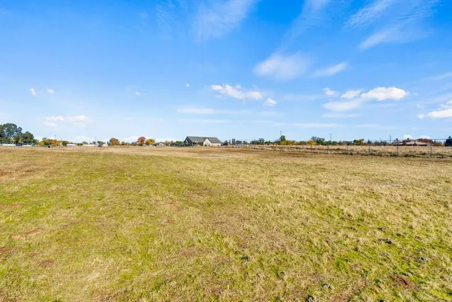 a view of a terrace with lawn chairs