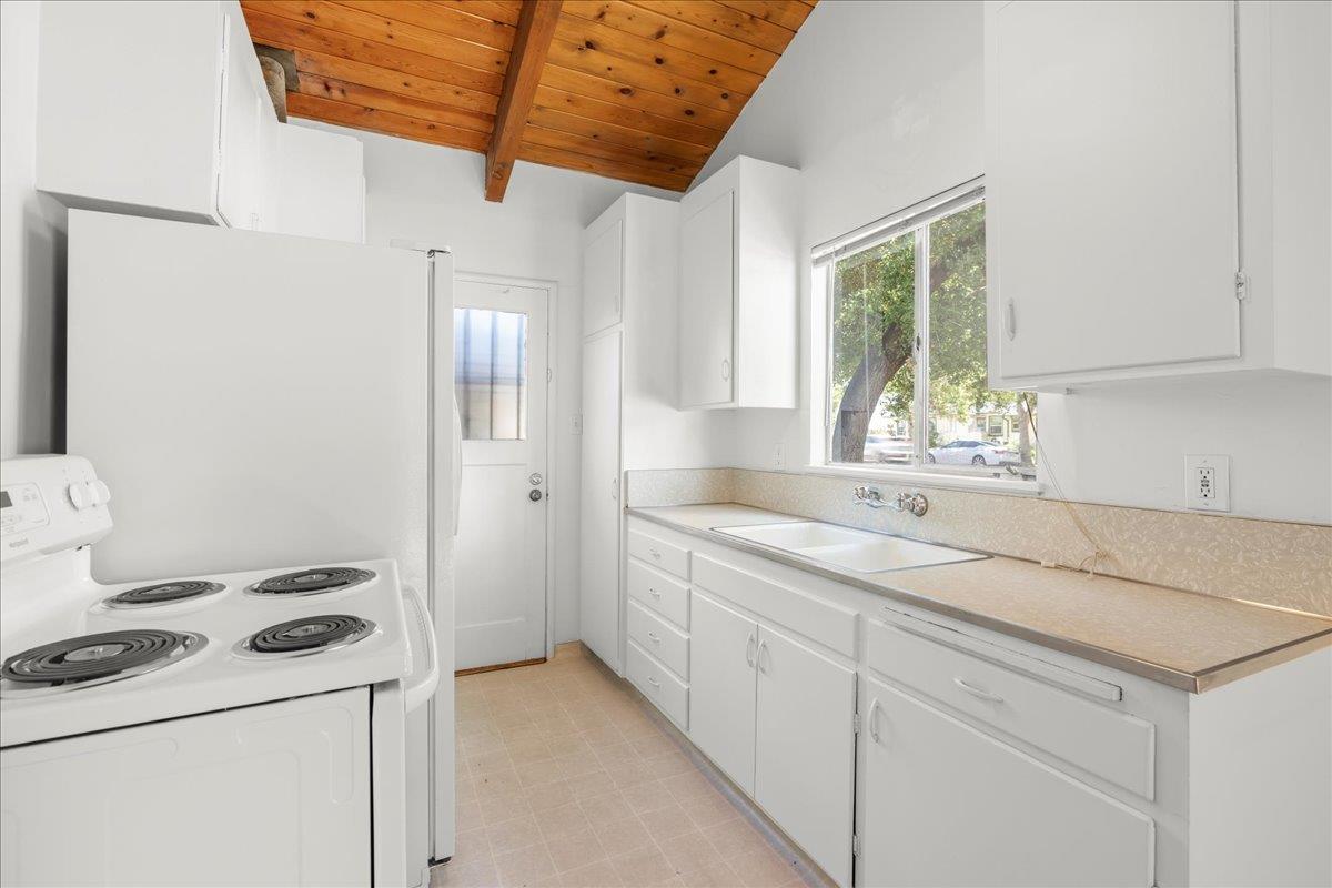 1556 Fourth Street Livermore, CA 94550 - Photo 9 of 18 a kitchen with a sink stove and cabinets