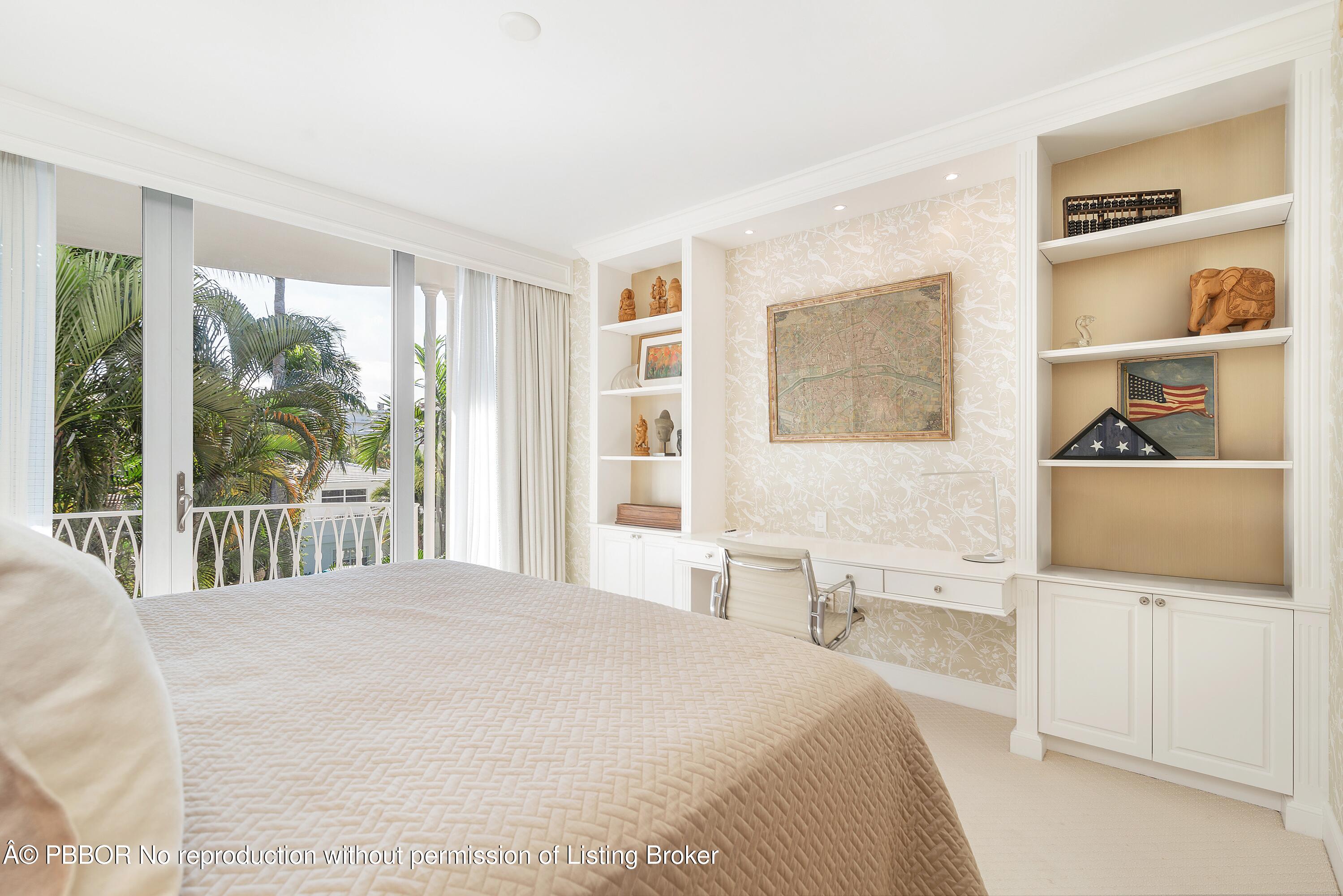 429 Australian Avenue, Unit 110 Palm Beach, FL 33480 - Photo 11 of 18 a bedroom with a large bed and a flat tv screen