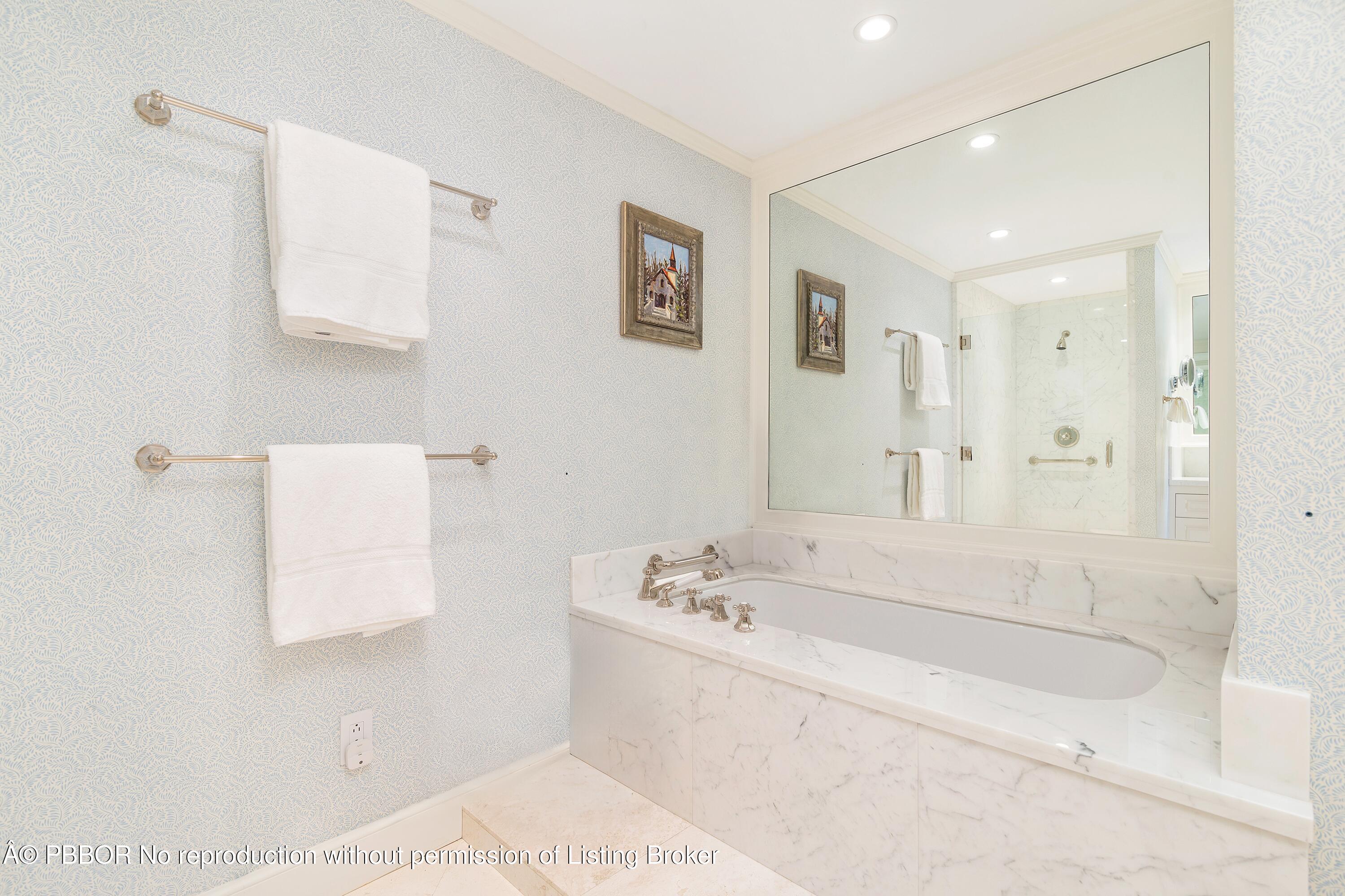 429 Australian Avenue, Unit 110 Palm Beach, FL 33480 - Photo 9 of 18 a bathroom with a tub sink and mirror