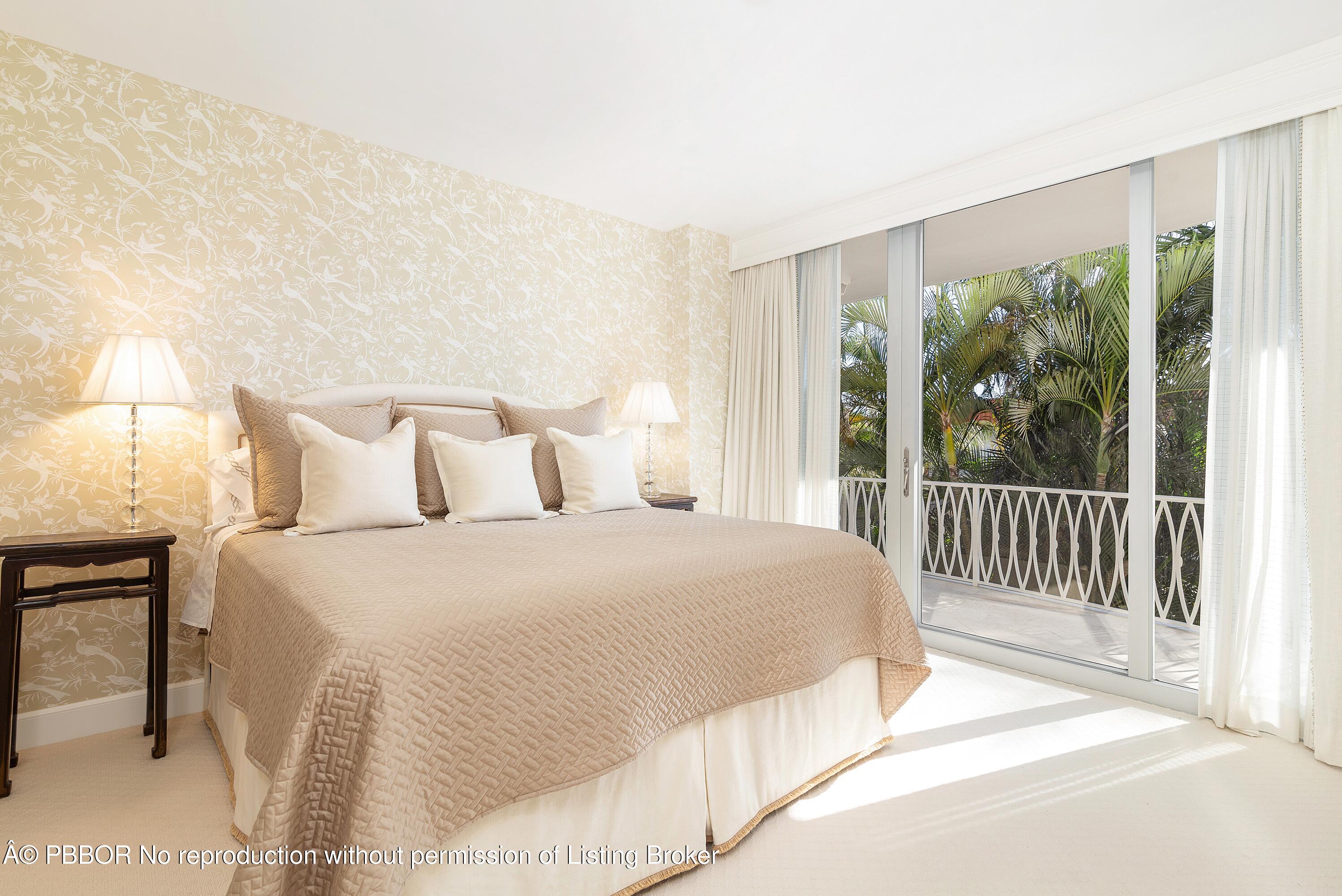 429 Australian Avenue, Unit 110 Palm Beach, FL 33480 - Photo 10 of 18 a bedroom with a bed and a large window