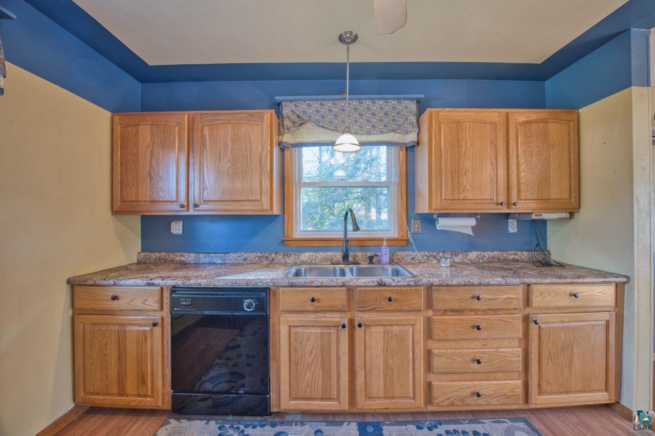 5316 Highway 110 Aurora, MN 55705 - Photo 8 of 35 Kitchen with dishwasher, decorative light fixtures, brown cabinetry, and light wood-style flooring