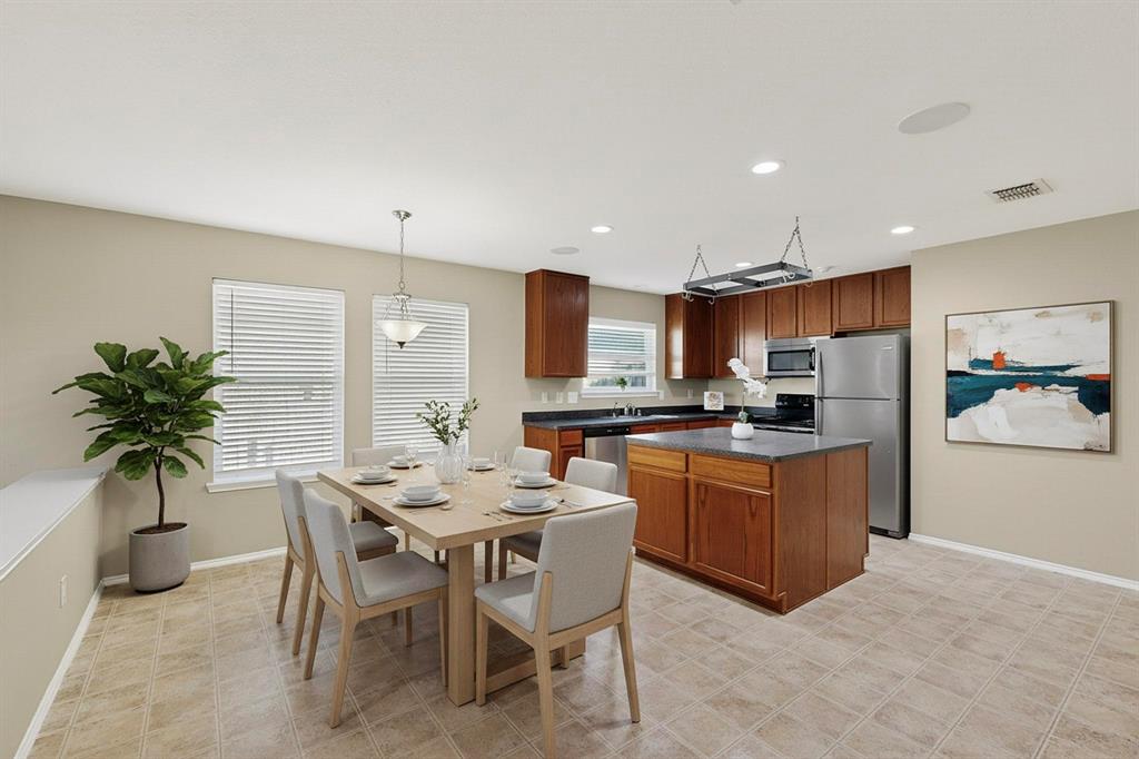 2114 Cypress Way Anna, TX 75409 - Photo 14 of 40 a kitchen with a table and chairs in it