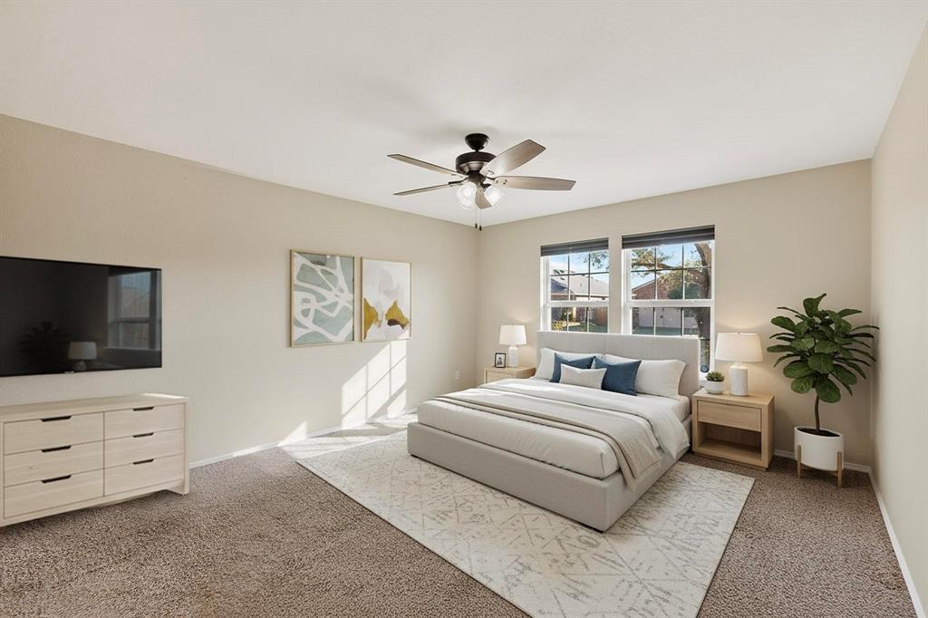 2114 Cypress Way Anna, TX 75409 - Photo 18 of 40 a bedroom with a bed and a flat screen tv