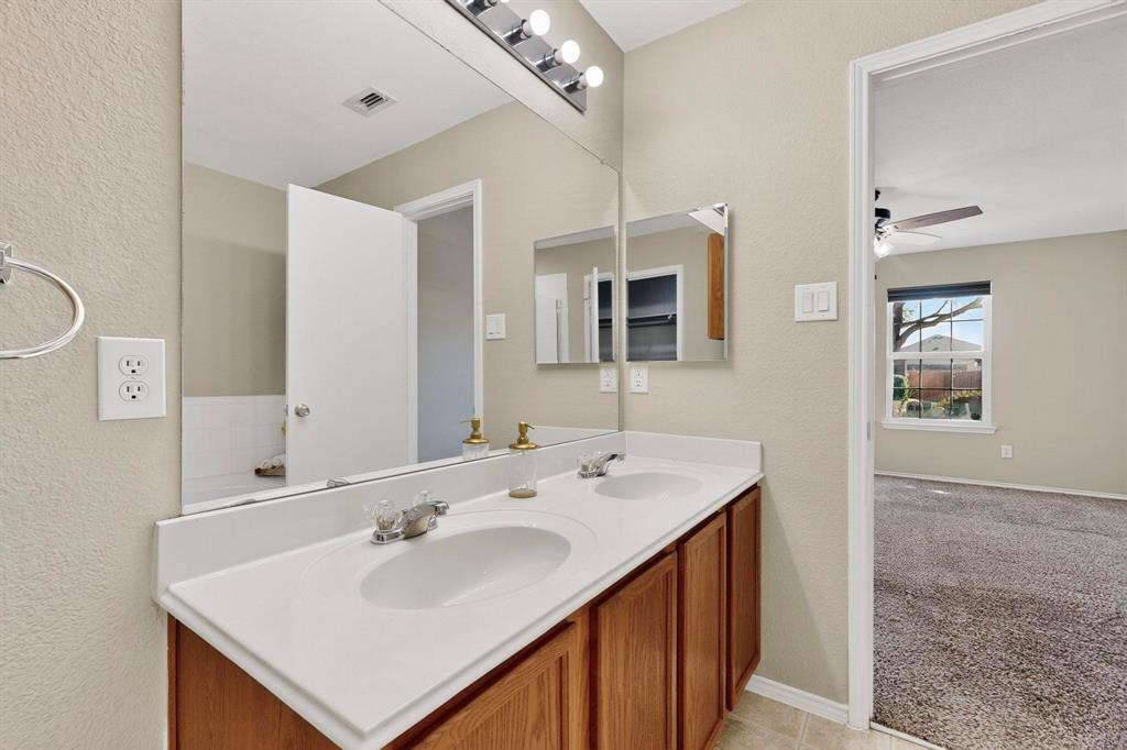 2114 Cypress Way Anna, TX 75409 - Photo 20 of 40 a bathroom with a sink and a mirror