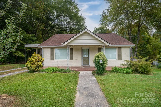 a front view of a house with a garden and porch