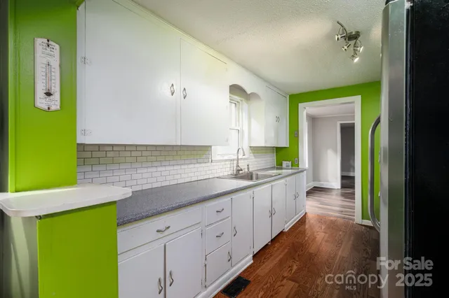 a spacious bathroom with a sink and mirror