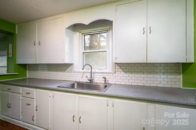 a kitchen with sink and cabinets