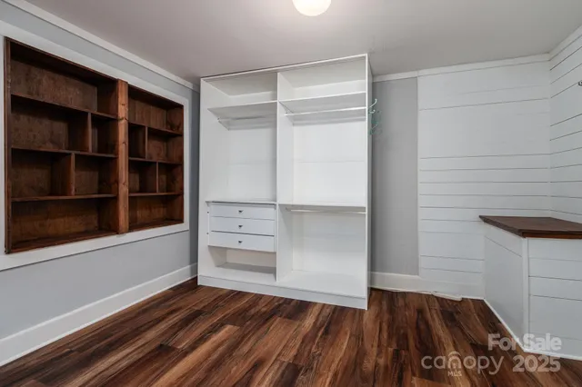 a view of walk in closet with empty racks