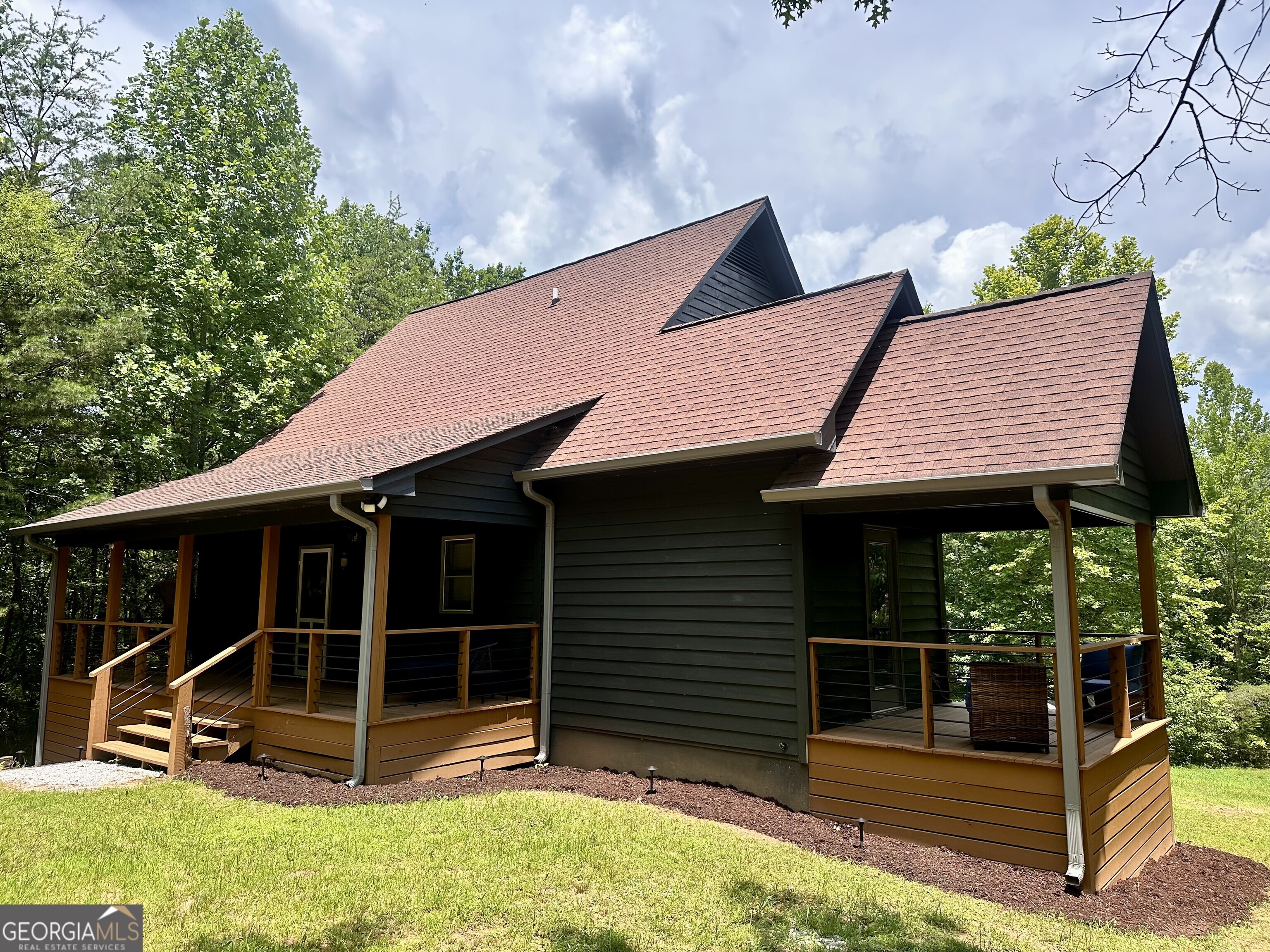 2769 Bean Creek Road Sautee Nacoochee, GA 30571 - Photo 2 of 33 a backyard of a house with table and chairs