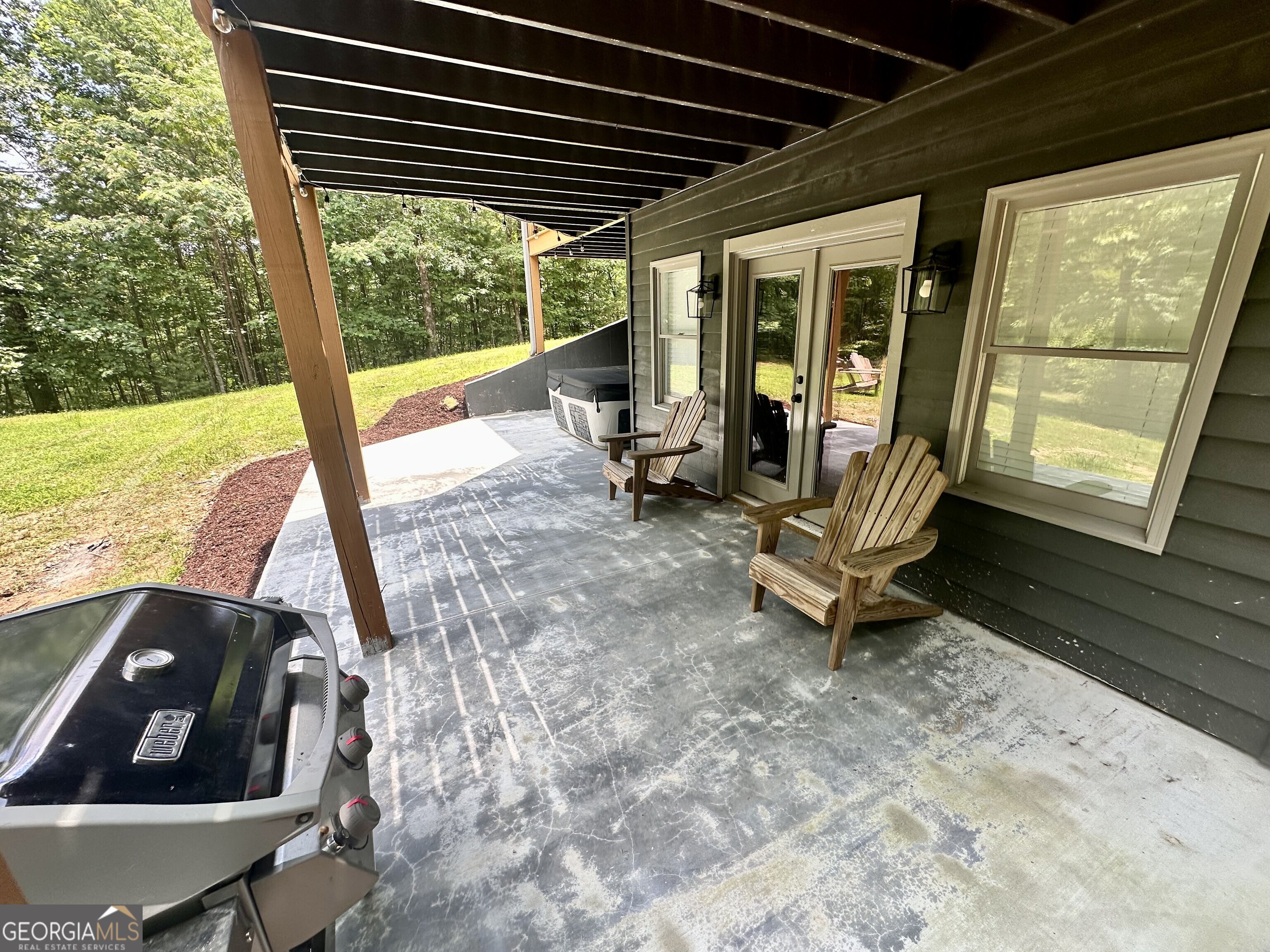2769 Bean Creek Road Sautee Nacoochee, GA 30571 - Photo 25 of 33 a view of a chairs and table in patio with a backyard