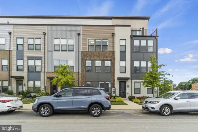 a front view of a residential apartment building with a yard