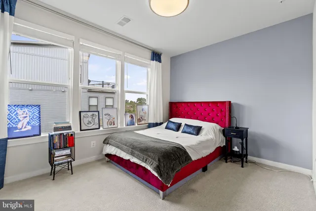 a bed sitting in a bedroom next to a window