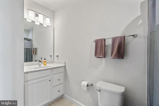 a bathroom with a shower curtain and a sink