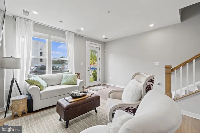 a kitchen with stainless steel appliances granite countertop a refrigerator a stove a sink and a microwave