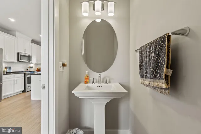 a kitchen with kitchen island white cabinets and appliances