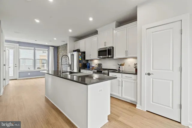 a kitchen with granite countertop a sink and a stove top oven
