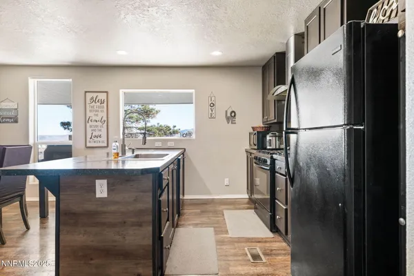 a kitchen with refrigerator and window