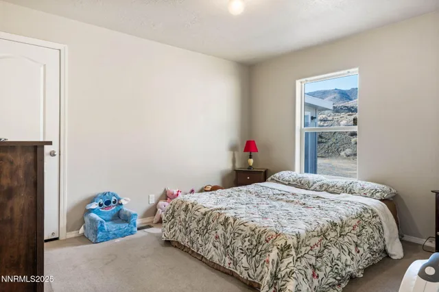 a bed room with a bed and a chair