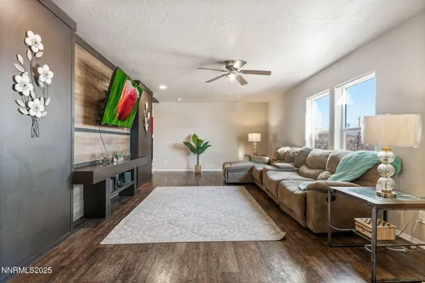 a living room with furniture fireplace and flat screen tv