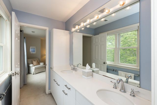 a bathroom with a double vanity sink and a mirror
