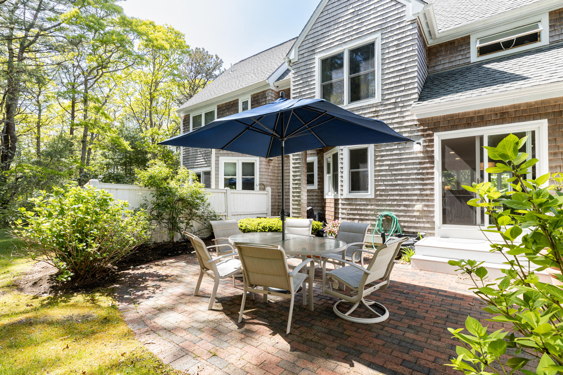 2 Bob White Crescent Mashpee, MA 02649 - Photo 37 of 47 a view of a patio with table and chairs under an umbrella