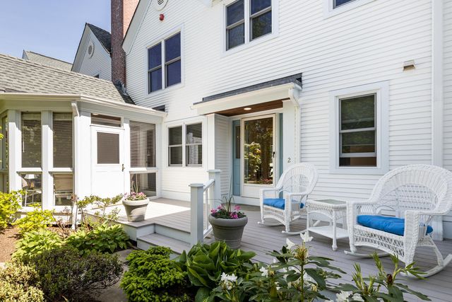 a view of a patio with couches table and chairs and potted plants