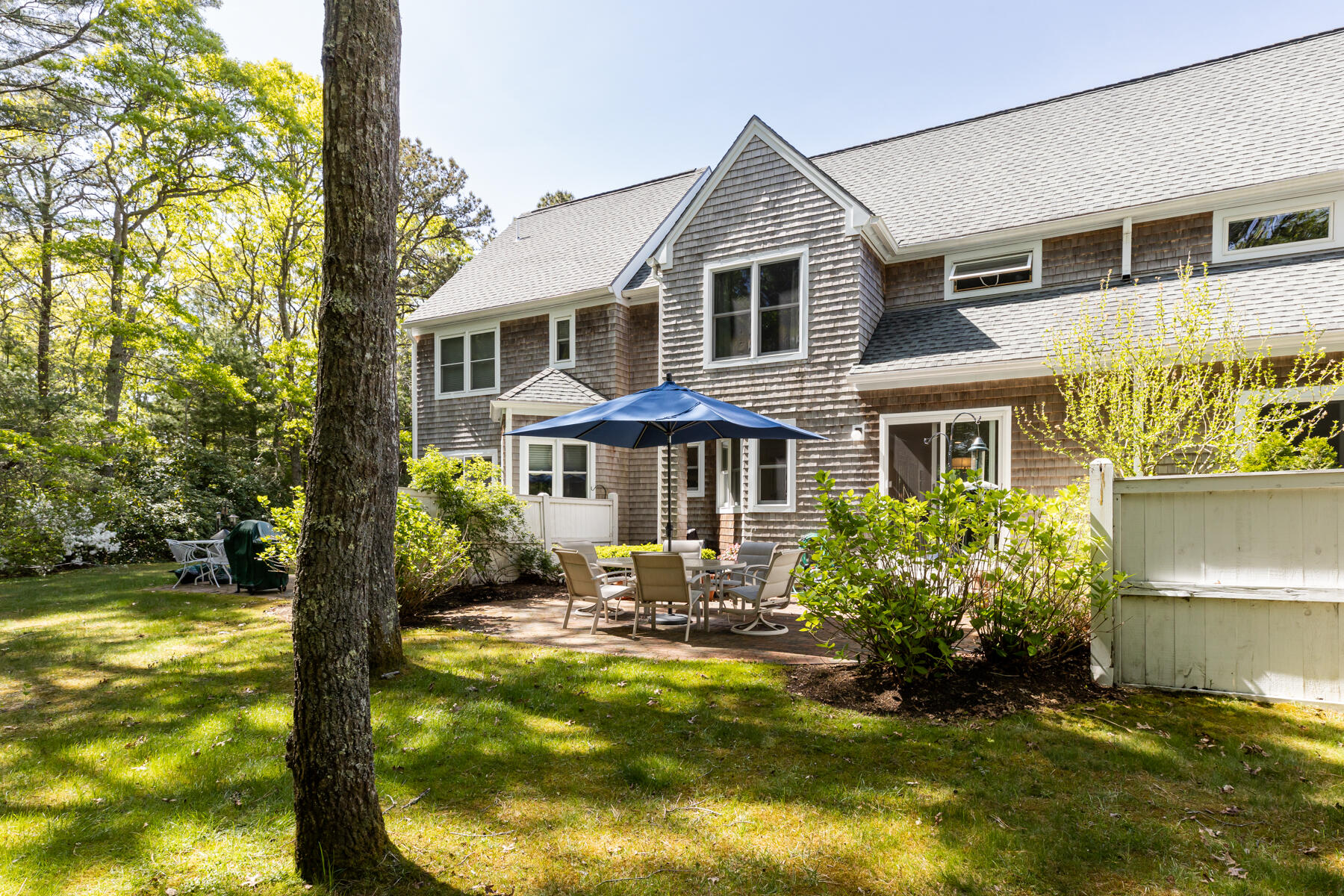 2 Bob White Crescent Mashpee, MA 02649 - Photo 41 of 47 a front view of a house with a yard table and chairs