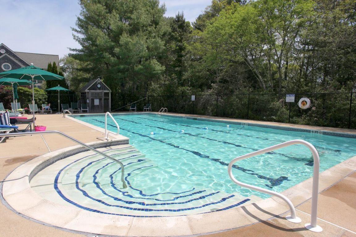 2 Bob White Crescent Mashpee, MA 02649 - Photo 42 of 47 a swimming pool with outdoor seating and garden