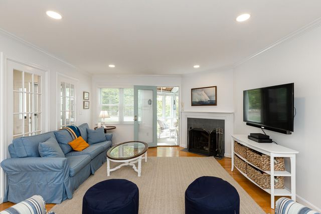 a living room with furniture fireplace and flat screen tv