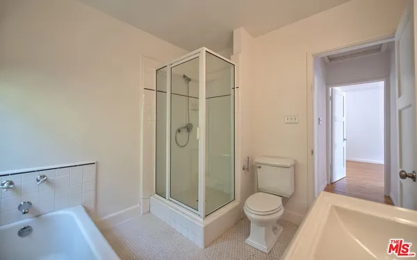 a bathroom with a toilet and a shower