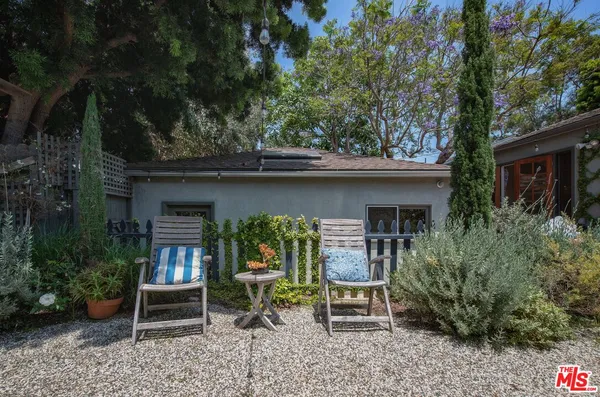 a view of house with a chairs in patio