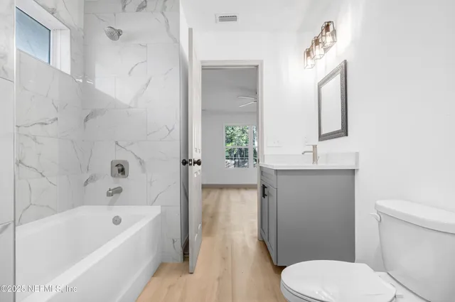 a bathroom with a sink a toilet and bathtub