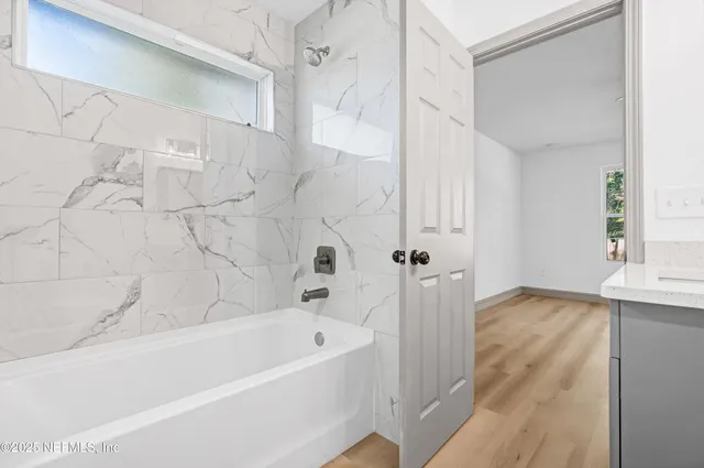 a bathroom with a bathtub and a shower
