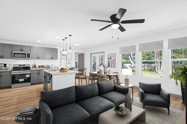 a living room with furniture kitchen and a window