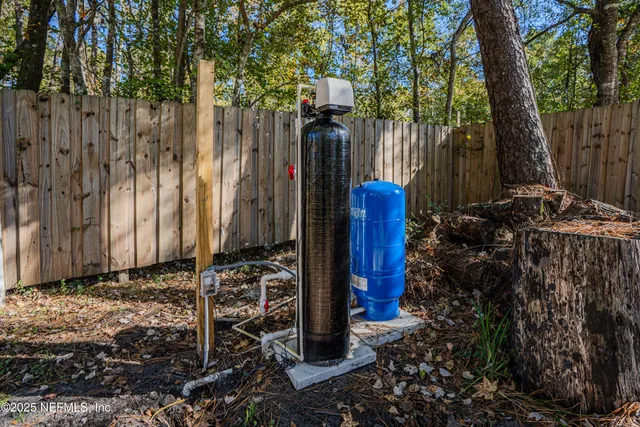 a view of a house with a backyard and trees