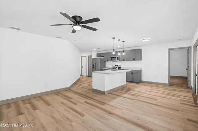 a view of kitchen with sink microwave and stove