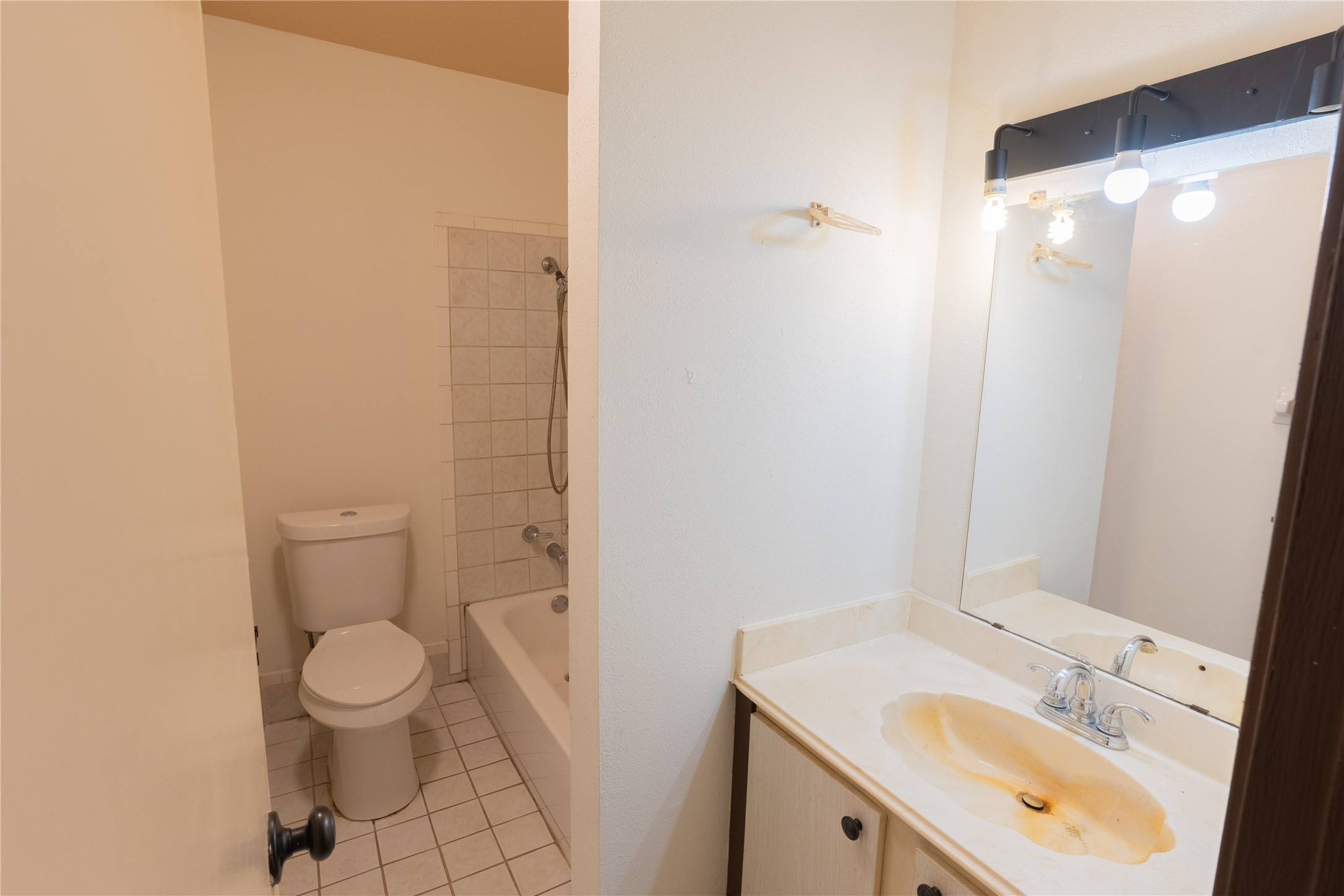 3314 Burke Road, Unit 39 Pasadena, TX 77504 - Photo 7 of 11 a bathroom with a sink a toilet and a mirror