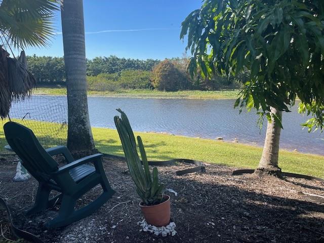 122 Dockside Circle Weston, FL 33327 - Photo 7 of 8 a view of a swimming pool with chair and table
