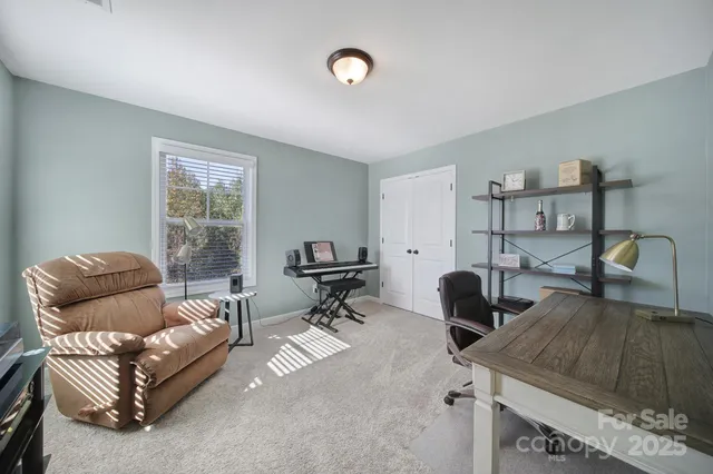 a view of a livingroom with furniture and a window