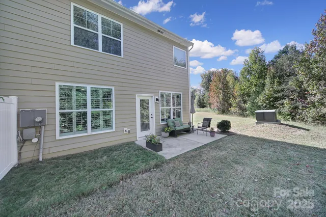a view of a house with backyard porch and sitting area