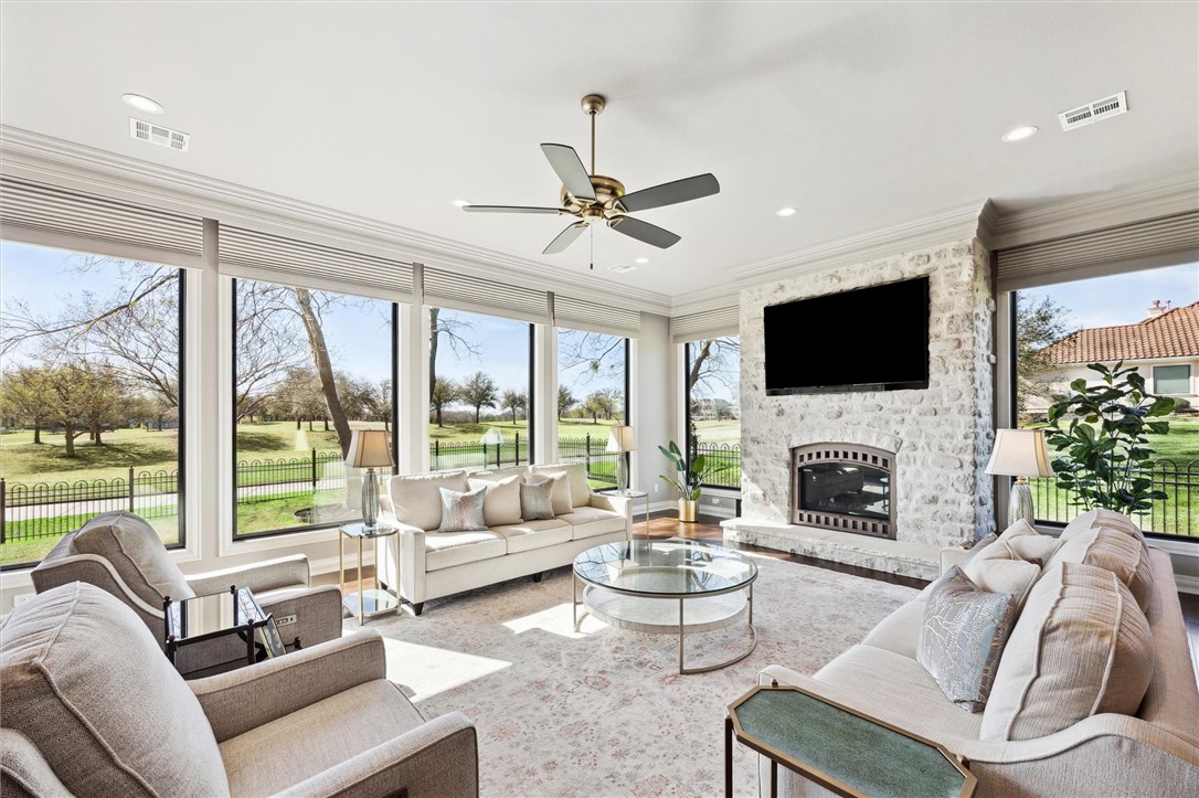 a living room with furniture fireplace and a large window