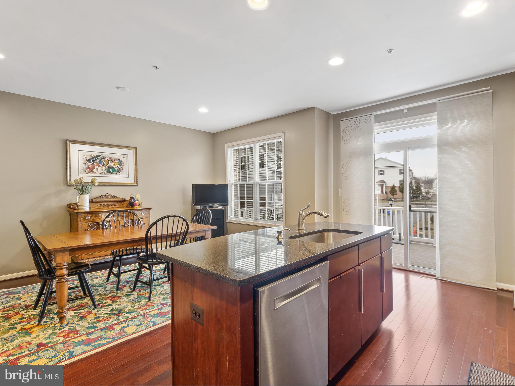 13610 Stargazer Lane Silver Spring, MD 20906 - Photo 21 of 43 a dining hall with stainless steel appliances granite countertop a table chairs and a refrigerator