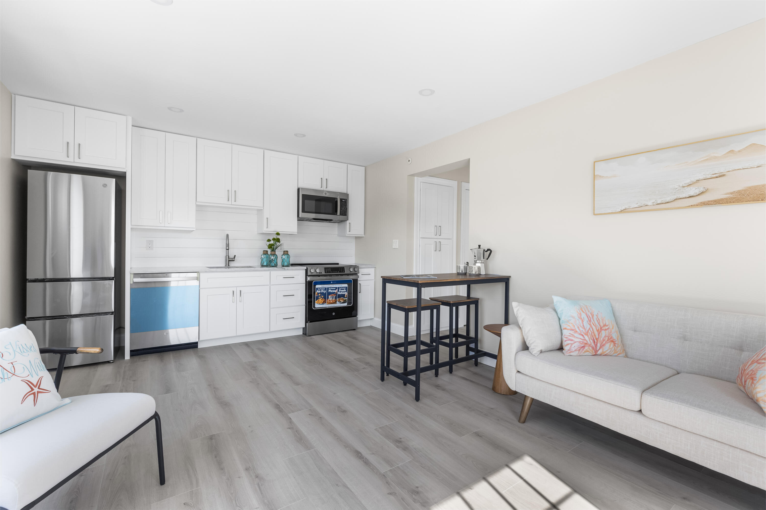 112 West Main Street, Unit 1 Barnstable, MA 02601 - Photo 3 of 15 a living room with stainless steel appliances furniture and a kitchen view