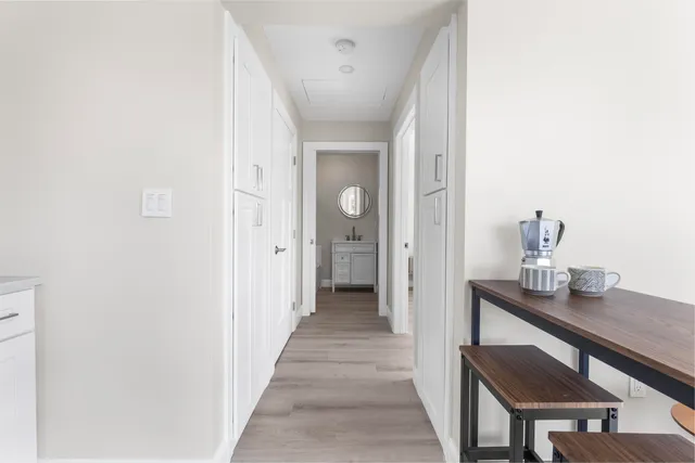 a view of a hallway to a livingroom and a hallway